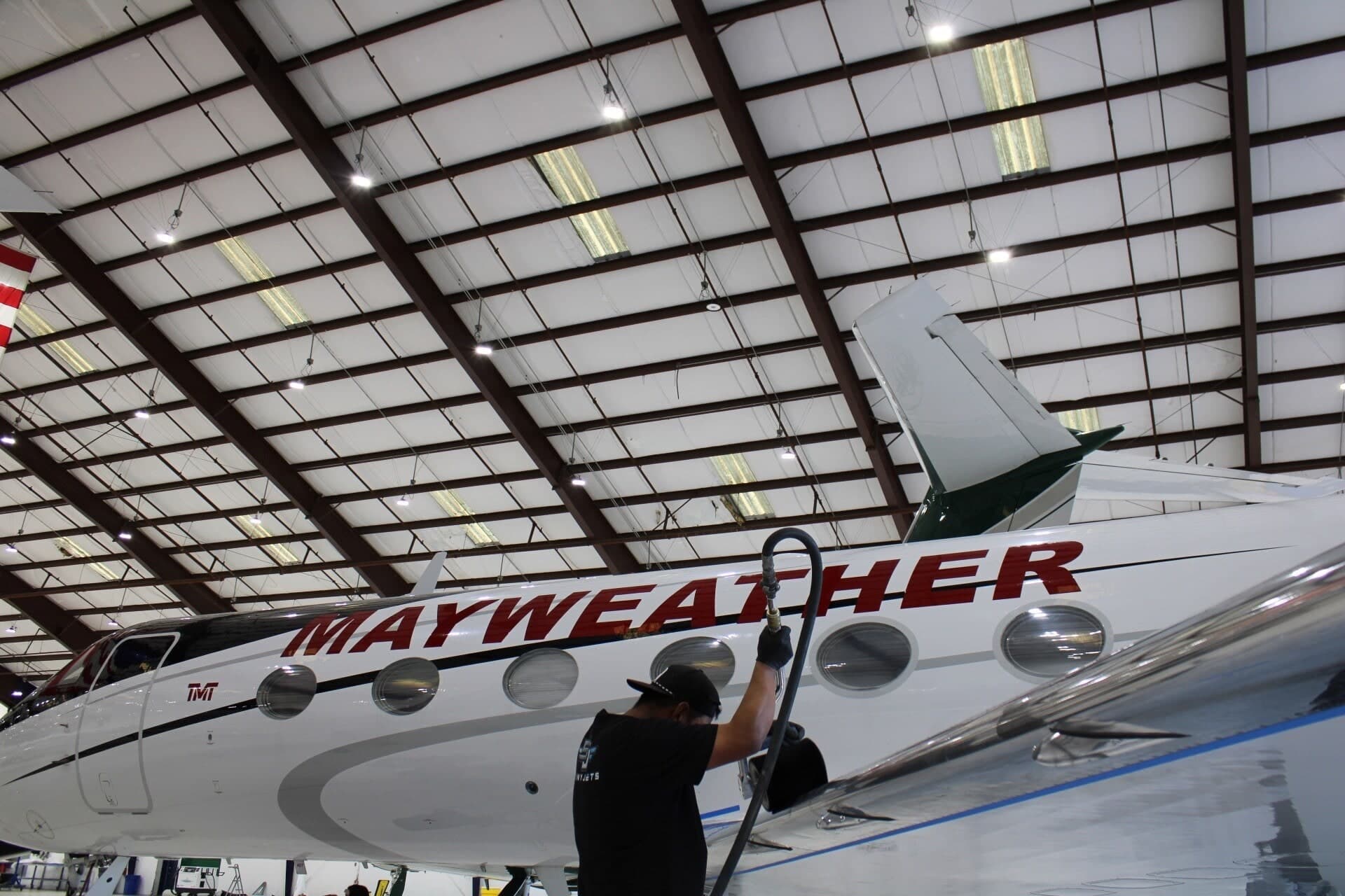 Aviation technician applying conditioner to rubber de-ice boots on wing